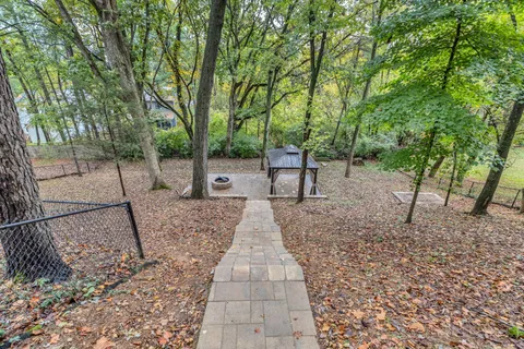 a view of a backyard with large trees