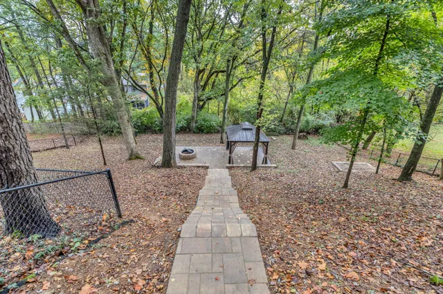 a view of a backyard with large trees