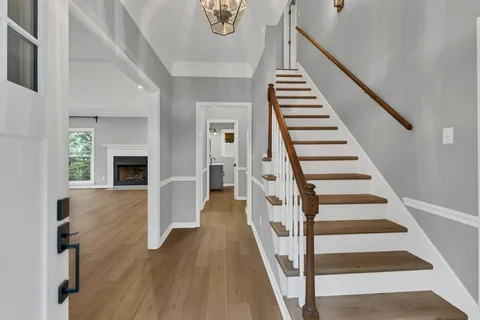 a view of entryway and hall with wooden floor