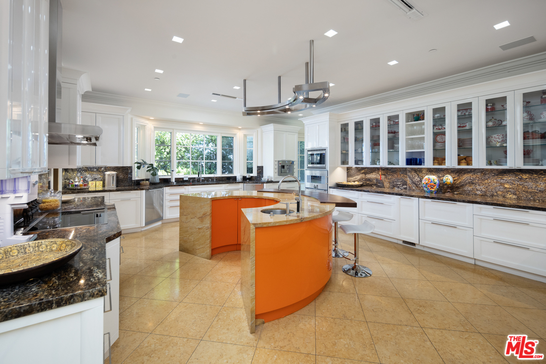 10 Beverly Park Beverly Hills, CA 90210 - Photo 14 of 33 a large kitchen with stainless steel appliances granite countertop a stove and a sink