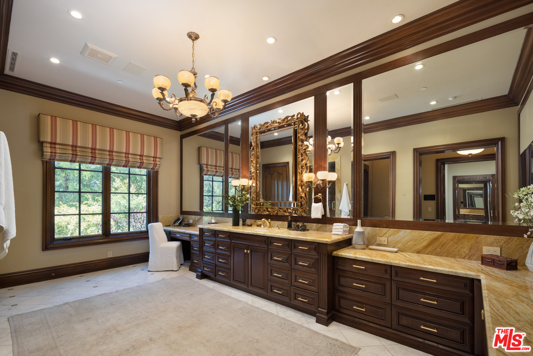 10 Beverly Park Beverly Hills, CA 90210 - Photo 20 of 33 a spacious bathroom with a sink mirror and a bathtub next to window