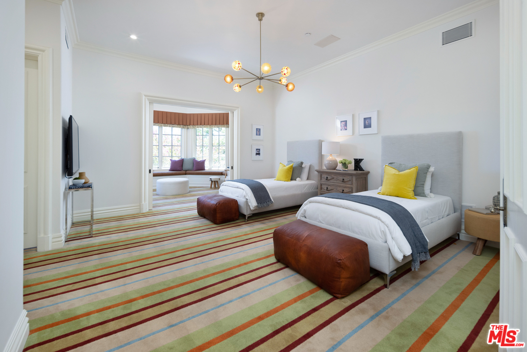 10 Beverly Park Beverly Hills, CA 90210 - Photo 22 of 33 a bedroom with two beds and a chandelier