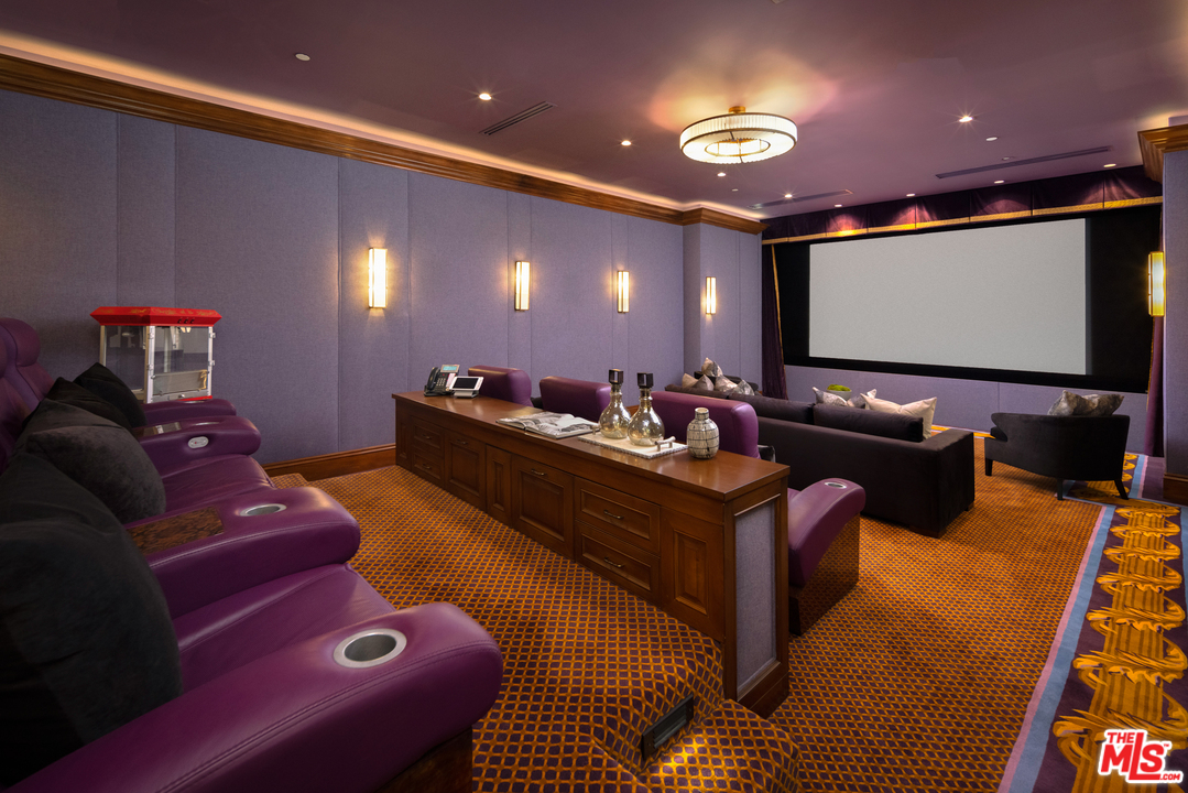 10 Beverly Park Beverly Hills, CA 90210 - Photo 24 of 33 a living room with furniture and a projector screen