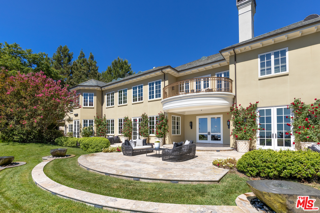 10 Beverly Park Beverly Hills, CA 90210 - Photo 25 of 33 a front view of a house with garden and trees