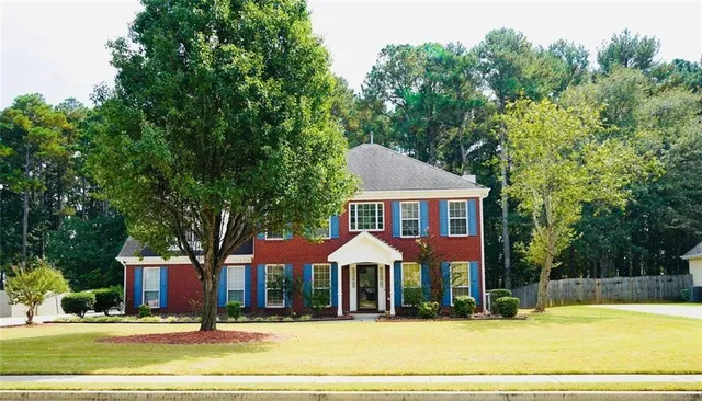 a front view of a house with a yard
