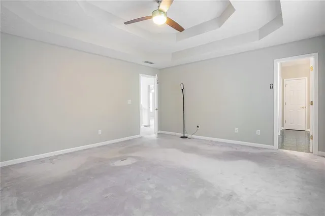 a view of an empty room with a ceiling fan