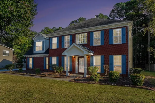 a front view of a house with a yard