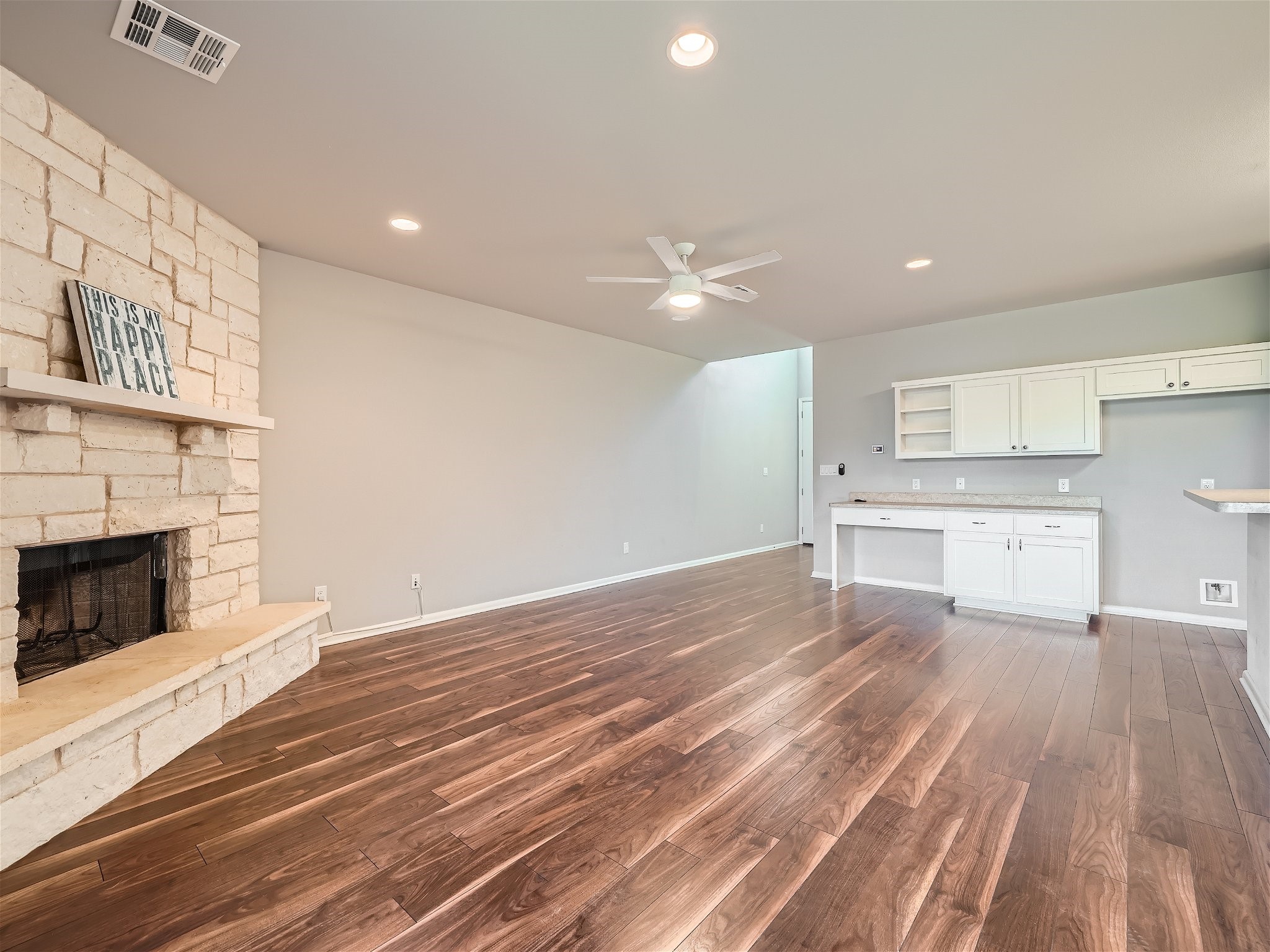 507 Venture Boulevard South Point Venture, TX 78645 - Photo 11 of 31 a view of kitchen and empty room with wooden floor