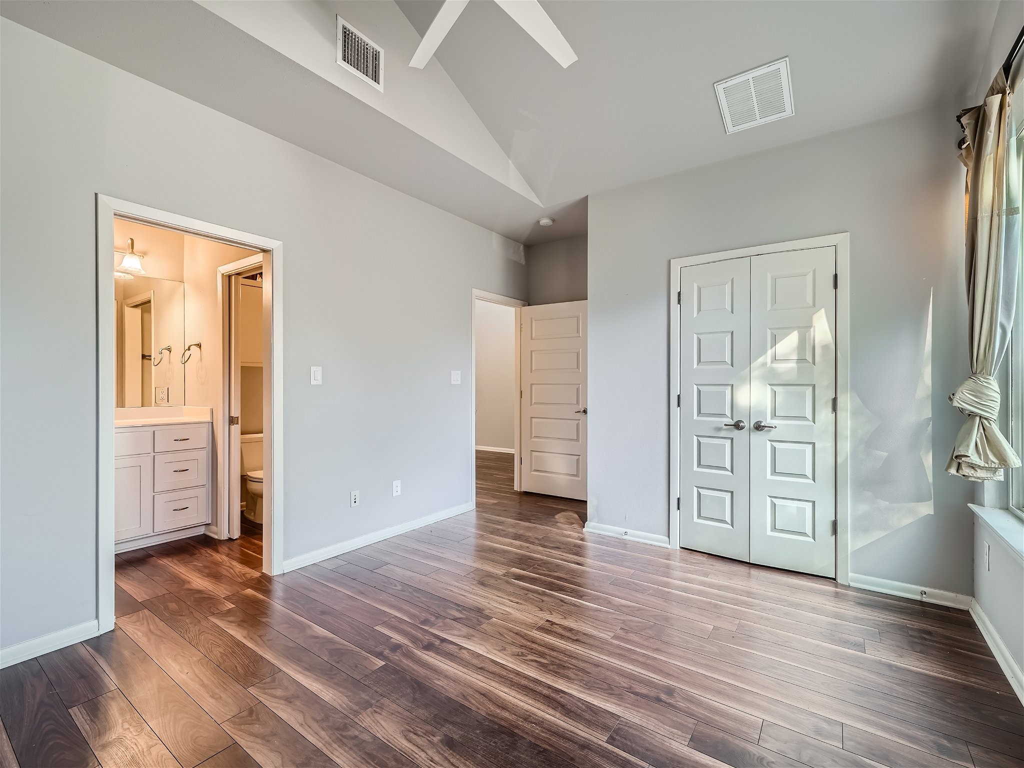 507 Venture Boulevard South Point Venture, TX 78645 - Photo 19 of 31 an empty room with wooden floor and bathroom view