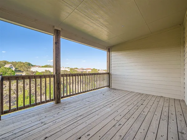 a view of a balcony with wooden floor