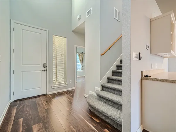 a view of entryway with wooden floor and staircase