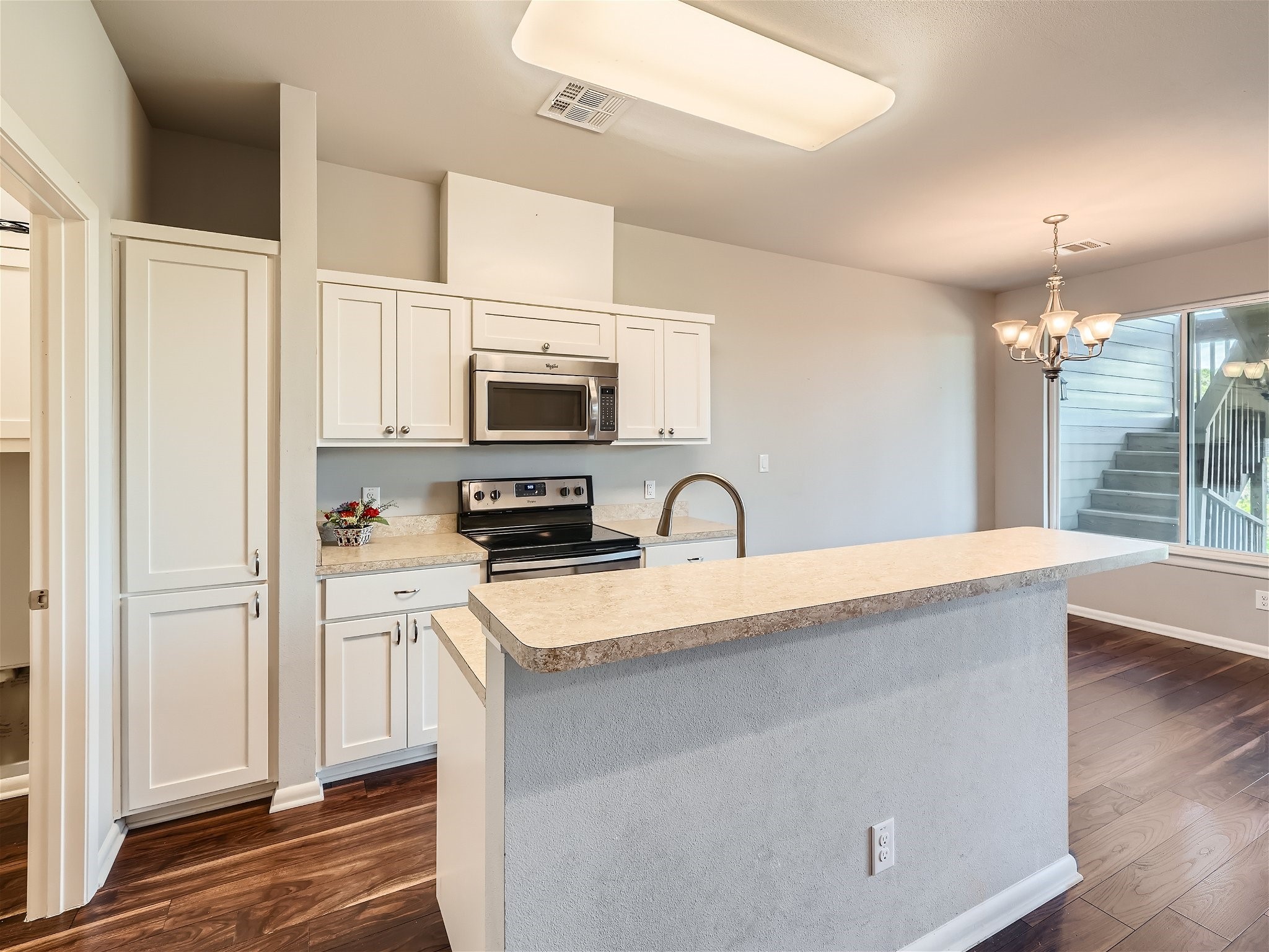 507 Venture Boulevard South Point Venture, TX 78645 - Photo 27 of 31 a kitchen with stainless steel appliances a sink microwave and stove