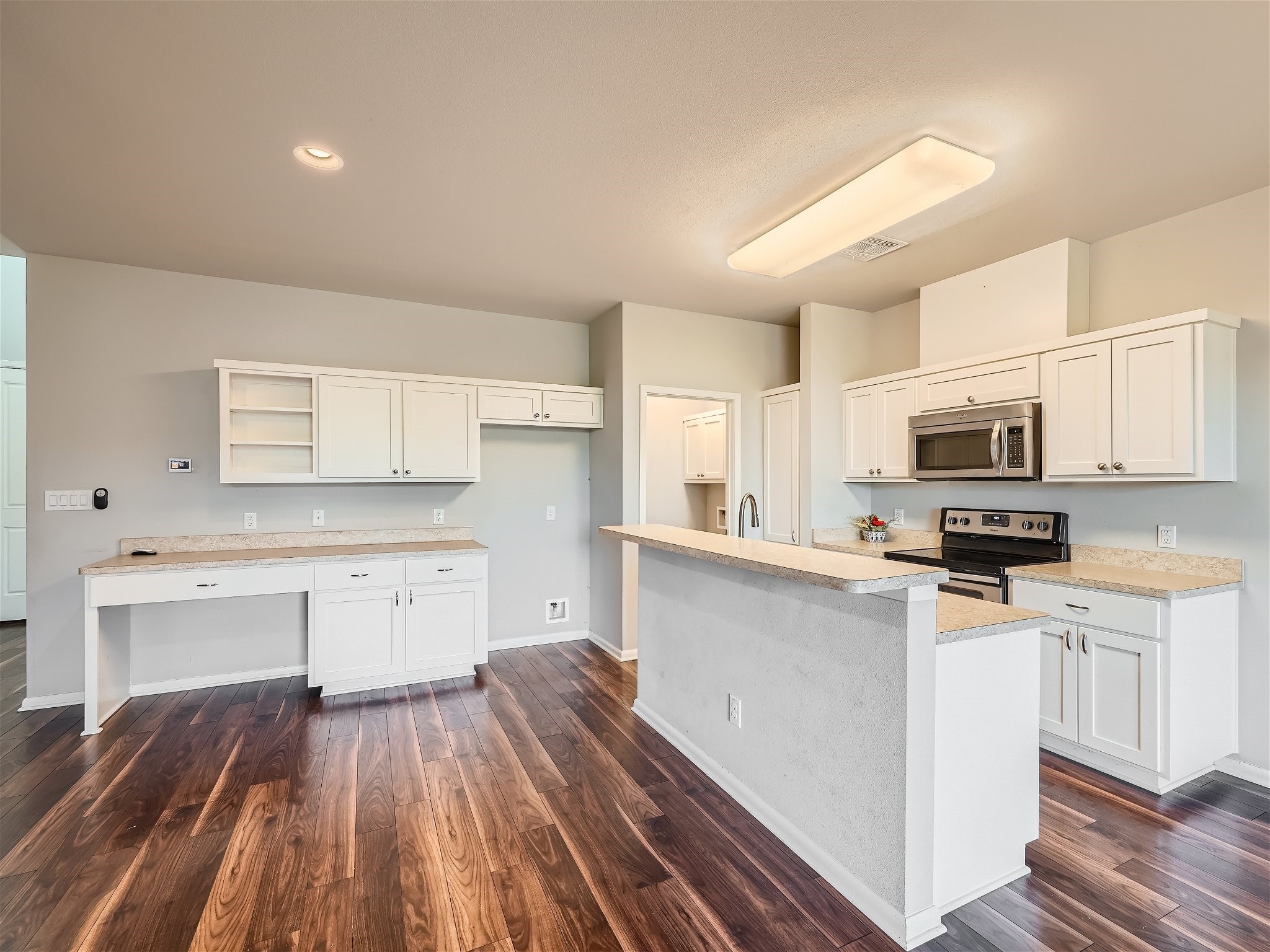 507 Venture Boulevard South Point Venture, TX 78645 - Photo 29 of 31 a kitchen with stainless steel appliances a stove top oven a sink cabinets and wooden floor