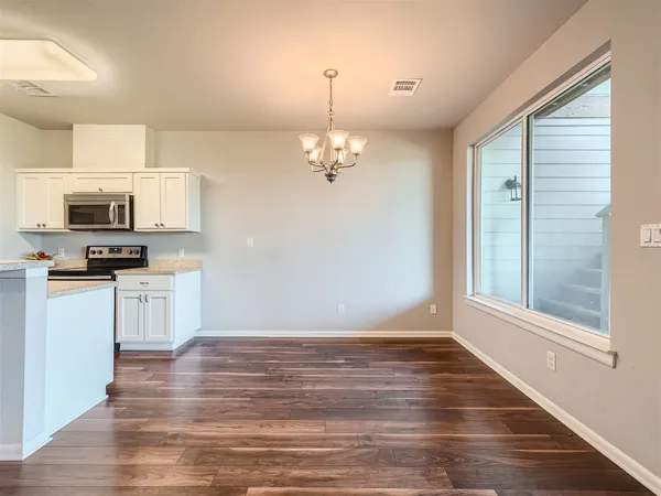 a view of a kitchen with stove and microwave