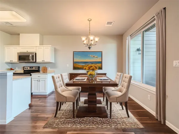 a view of a dining room with furniture window and wooden floor
