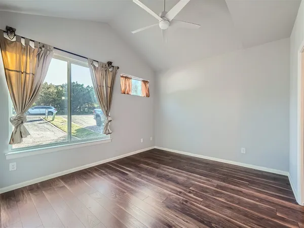 wooden floor in an empty room with a window