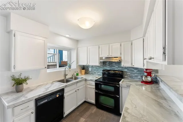 a kitchen with a sink white cabinets and white appliances