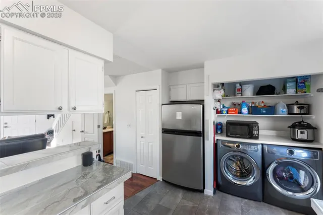 a kitchen with refrigerator and cabinets