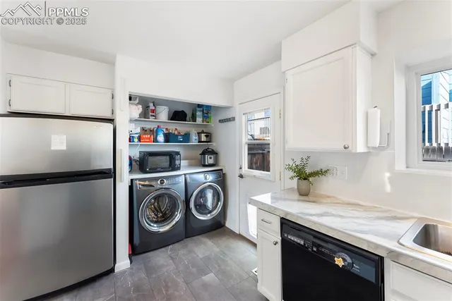 a utility room with sink dryer and washer