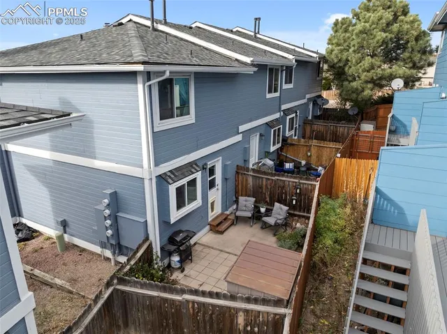 a view of a house with backyard and deck