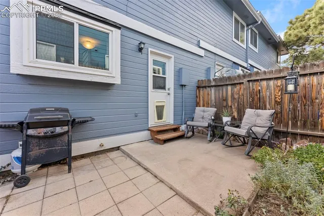 a view of a patio with table and chairs and potted plants