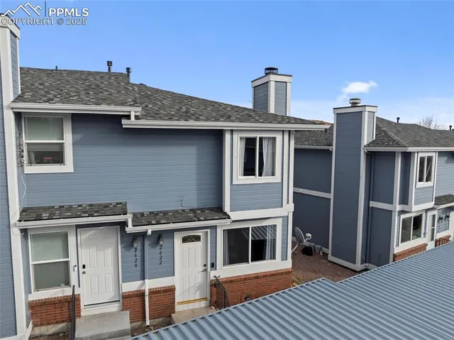 a front view of a house with large windows