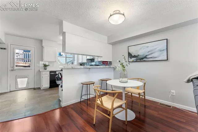 a dining room with furniture and wooden floor