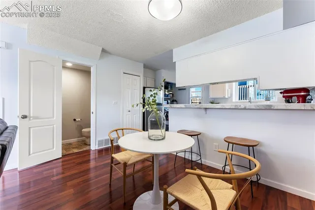 a dining room with furniture and wooden floor