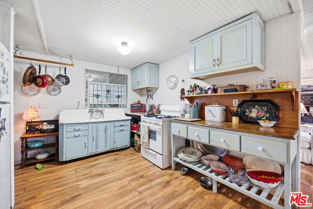 1667 Las Virgenes Canyon Road, Unit 5 Calabasas, CA 91302 - Photo 14 of 36 a kitchen with stainless steel appliances a stove and cabinets