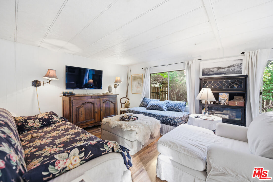 1667 Las Virgenes Canyon Road, Unit 5 Calabasas, CA 91302 - Photo 15 of 36 a bedroom with two beds and a couch