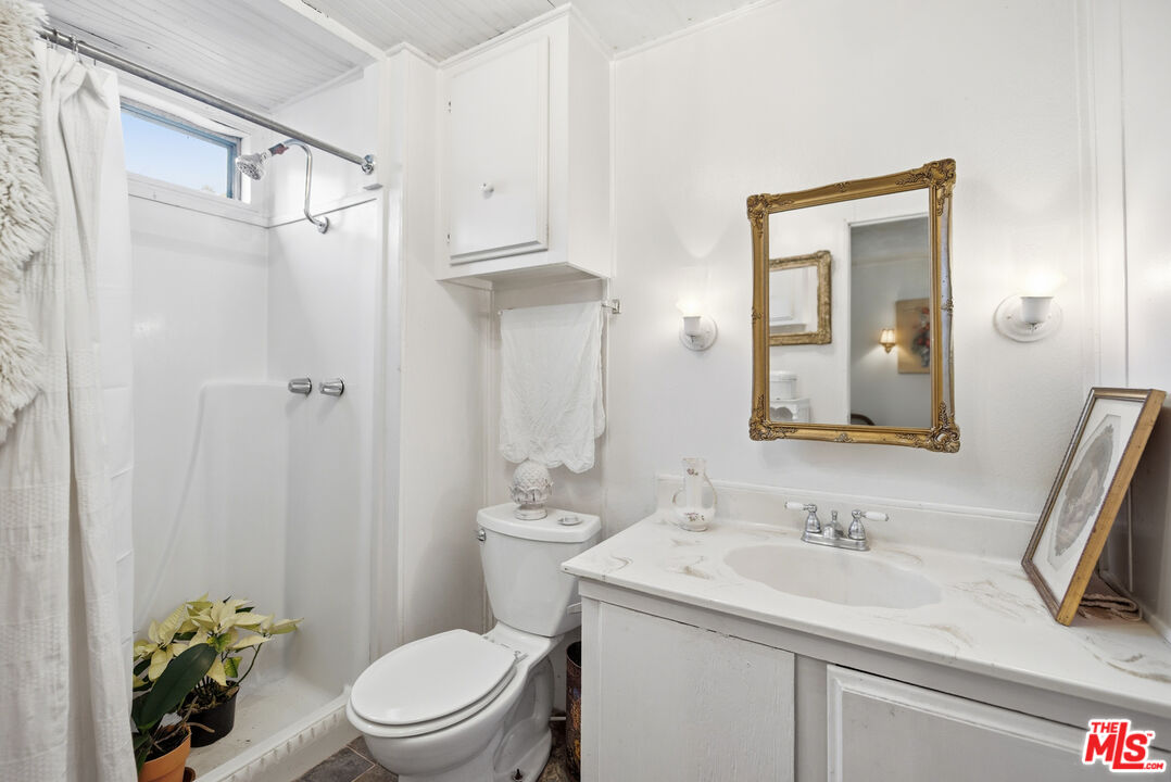 1667 Las Virgenes Canyon Road, Unit 5 Calabasas, CA 91302 - Photo 20 of 36 a bathroom with a sink toilet and shower
