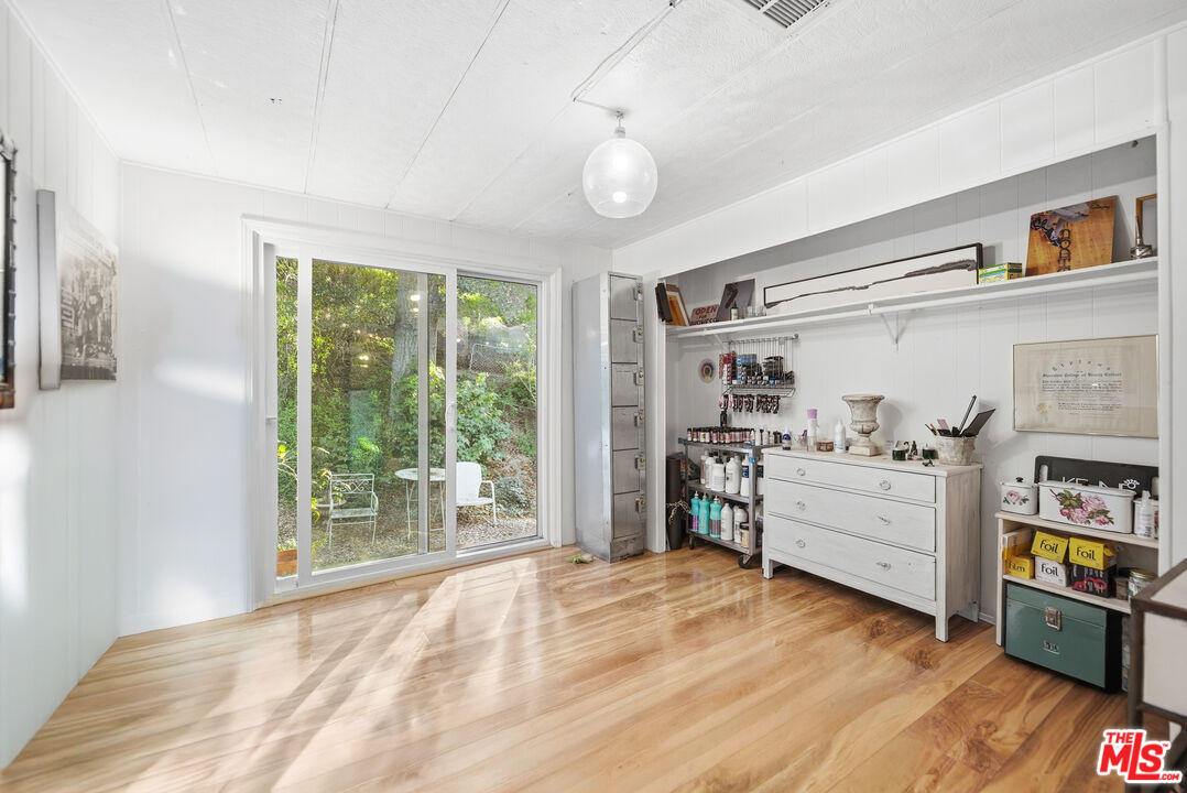 1667 Las Virgenes Canyon Road, Unit 5 Calabasas, CA 91302 - Photo 22 of 36 a room with furniture and a wooden floor