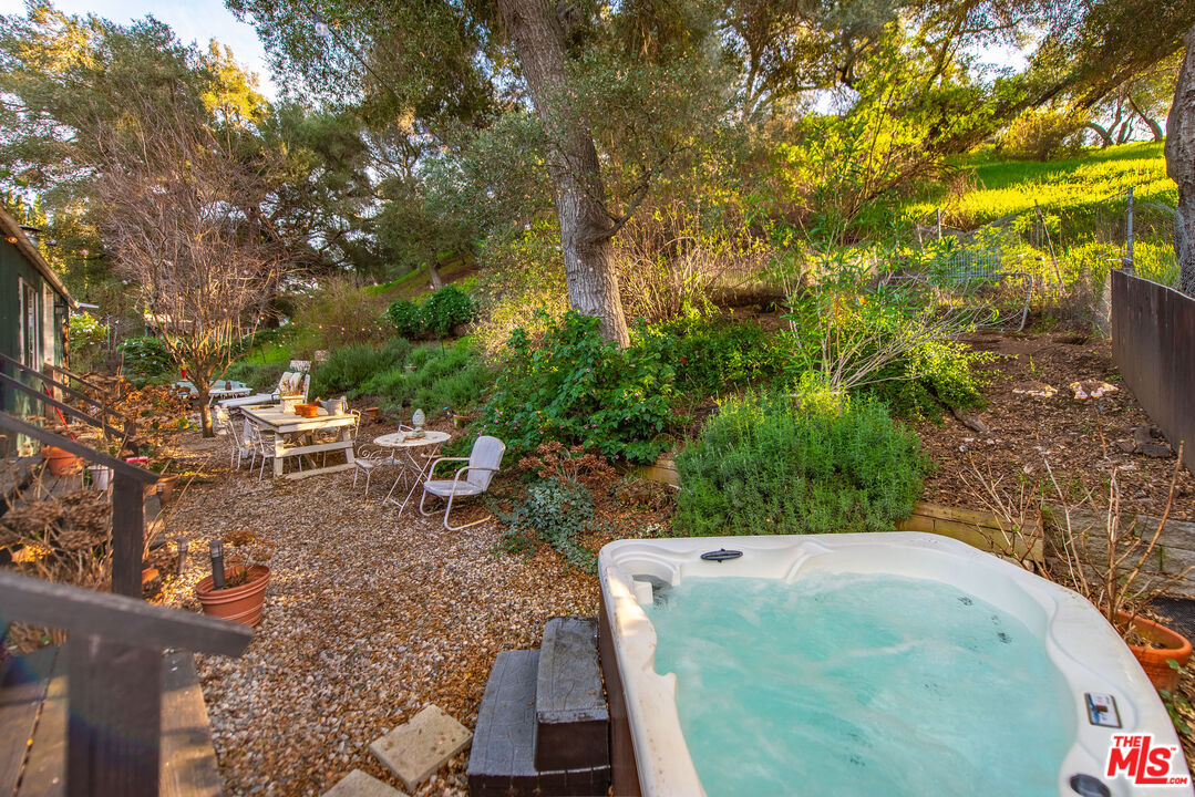1667 Las Virgenes Canyon Road, Unit 5 Calabasas, CA 91302 - Photo 23 of 36 a backyard of a house with table and chairs