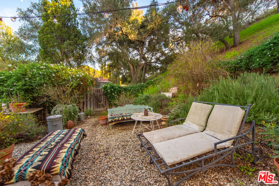 1667 Las Virgenes Canyon Road, Unit 5 Calabasas, CA 91302 - Photo 24 of 36 a view of a yard with furniture and a backyard