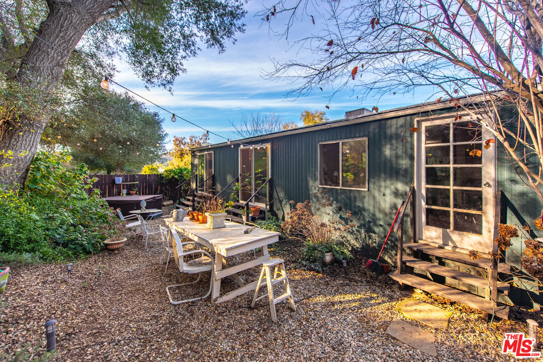 1667 Las Virgenes Canyon Road, Unit 5 Calabasas, CA 91302 - Photo 26 of 36 a view of a house with backyard sitting area and garden