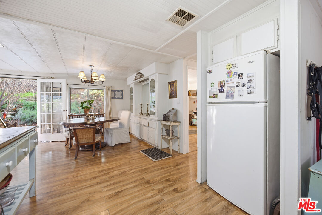 1667 Las Virgenes Canyon Road, Unit 5 Calabasas, CA 91302 - Photo 9 of 36 a view of a dining room with furniture window and wooden floor