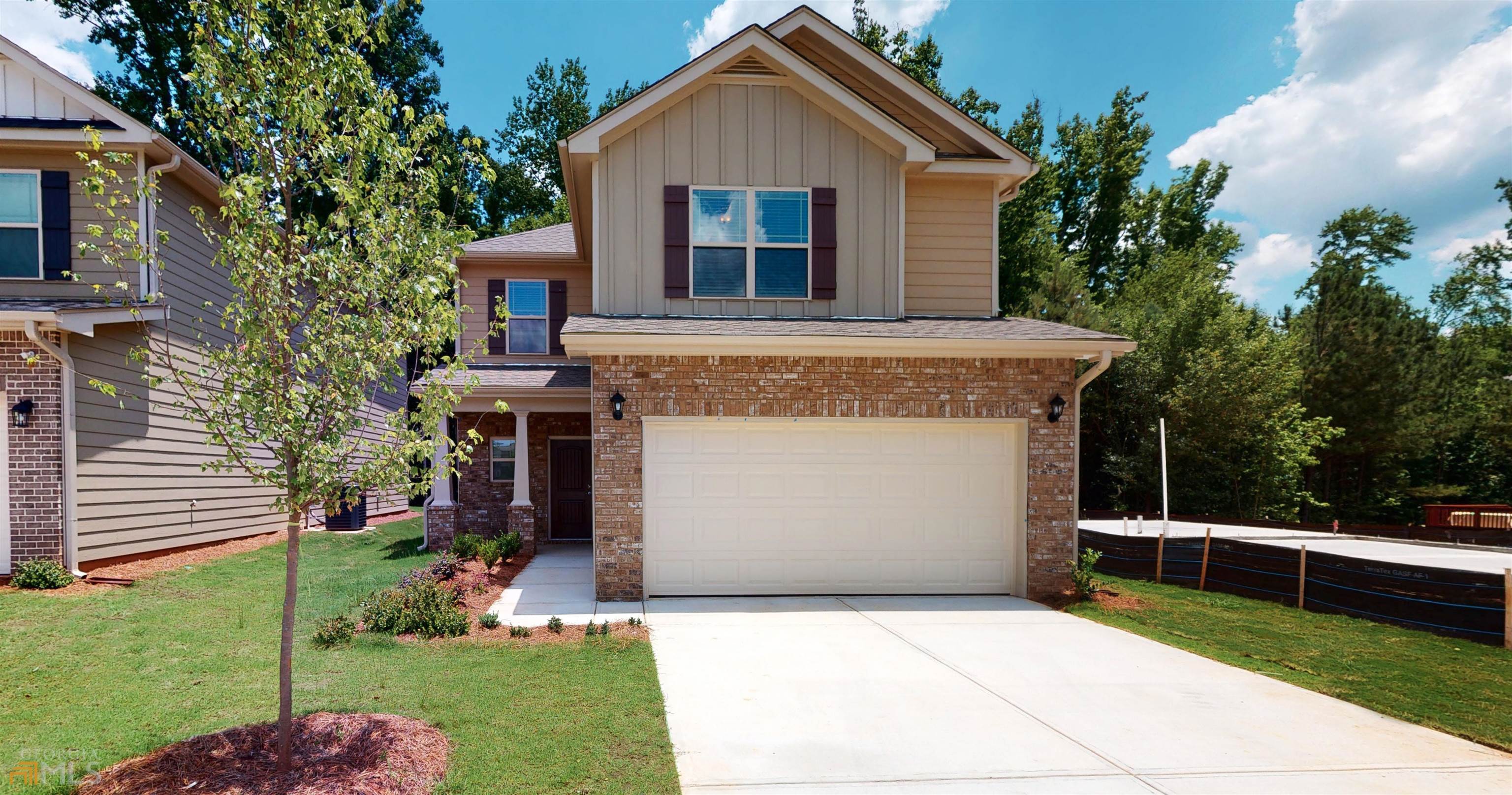 a front view of house with yard and green space