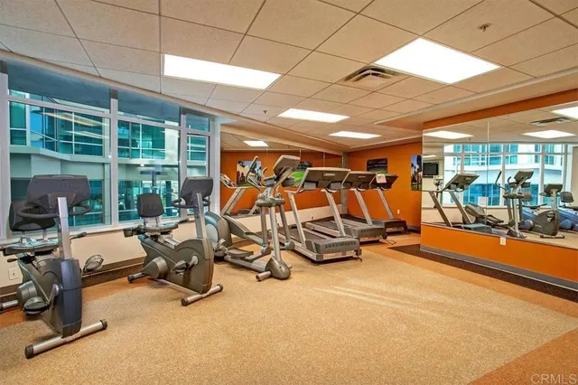 a living room with furniture kitchen view and a large window