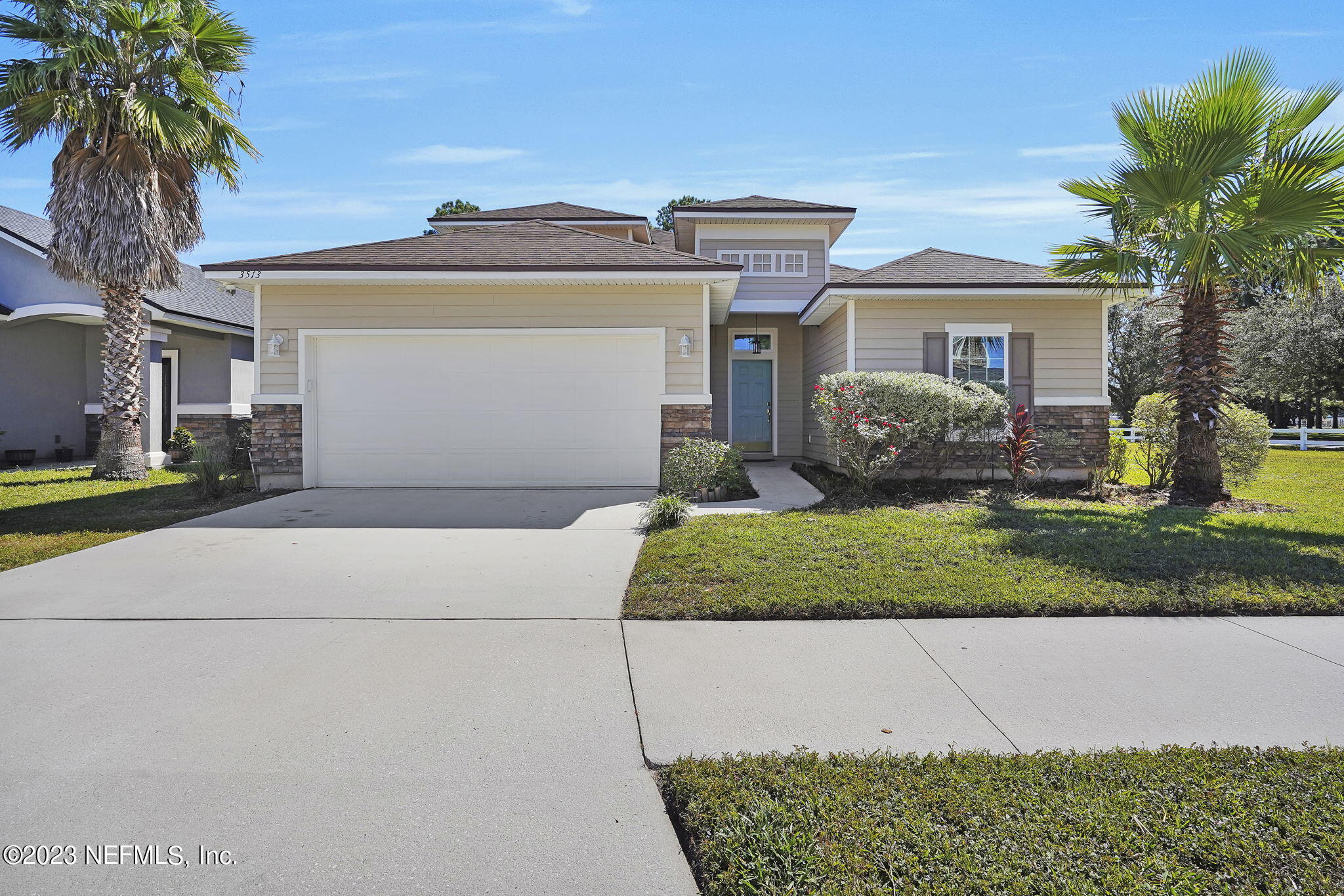 3513 Butternut Way Orange Park, FL 32065 - Photo 1 of 38 a front view of a house with a garden and plants