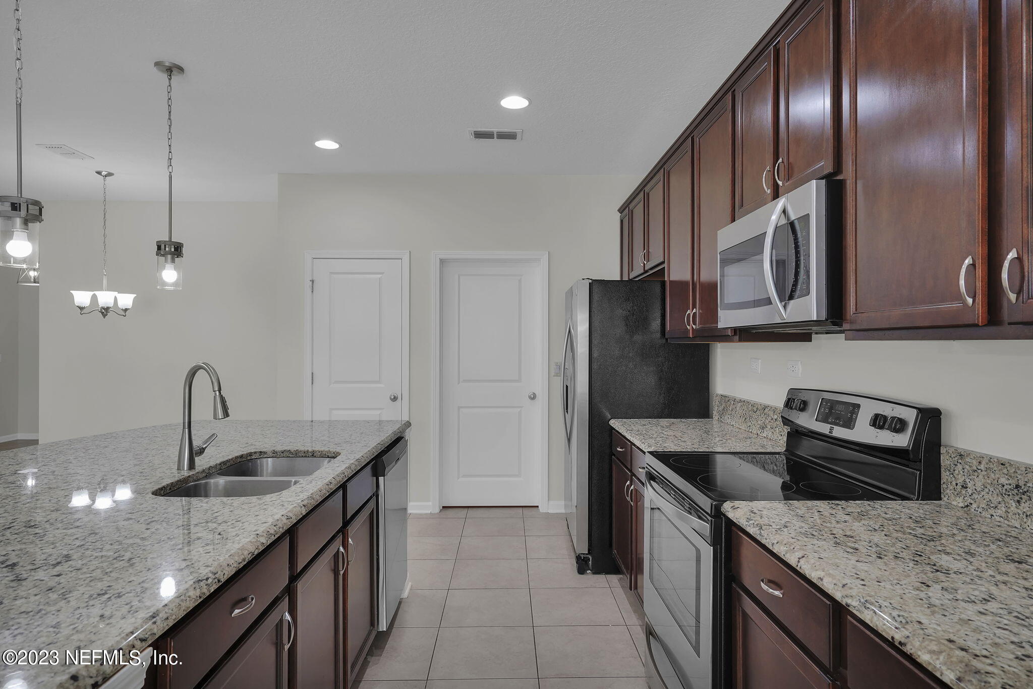 3513 Butternut Way Orange Park, FL 32065 - Photo 12 of 38 a kitchen with stainless steel appliances granite countertop a sink a stove and a refrigerator