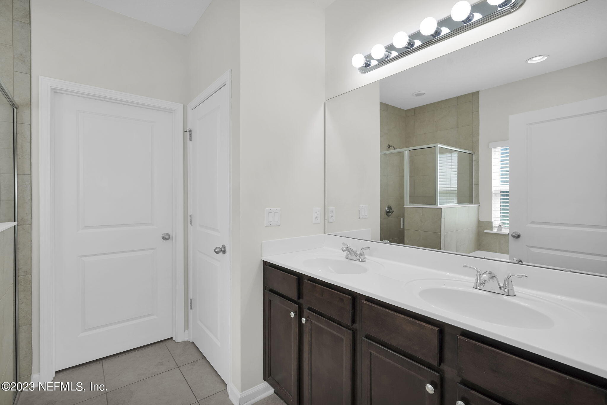 3513 Butternut Way Orange Park, FL 32065 - Photo 19 of 38 a bathroom with double vanity sinks and a mirror