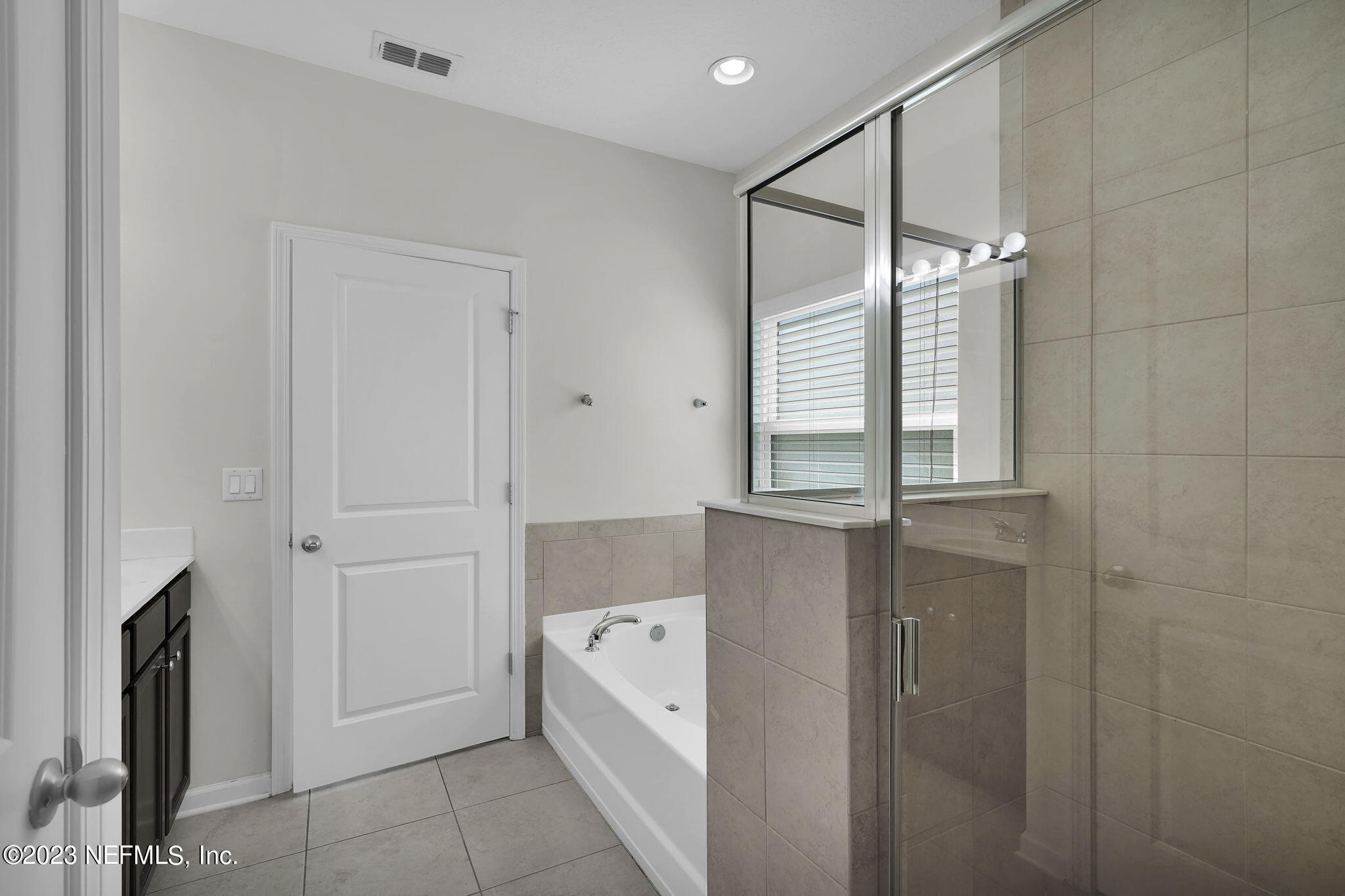 3513 Butternut Way Orange Park, FL 32065 - Photo 20 of 38 a bathroom with a bathtub and shower