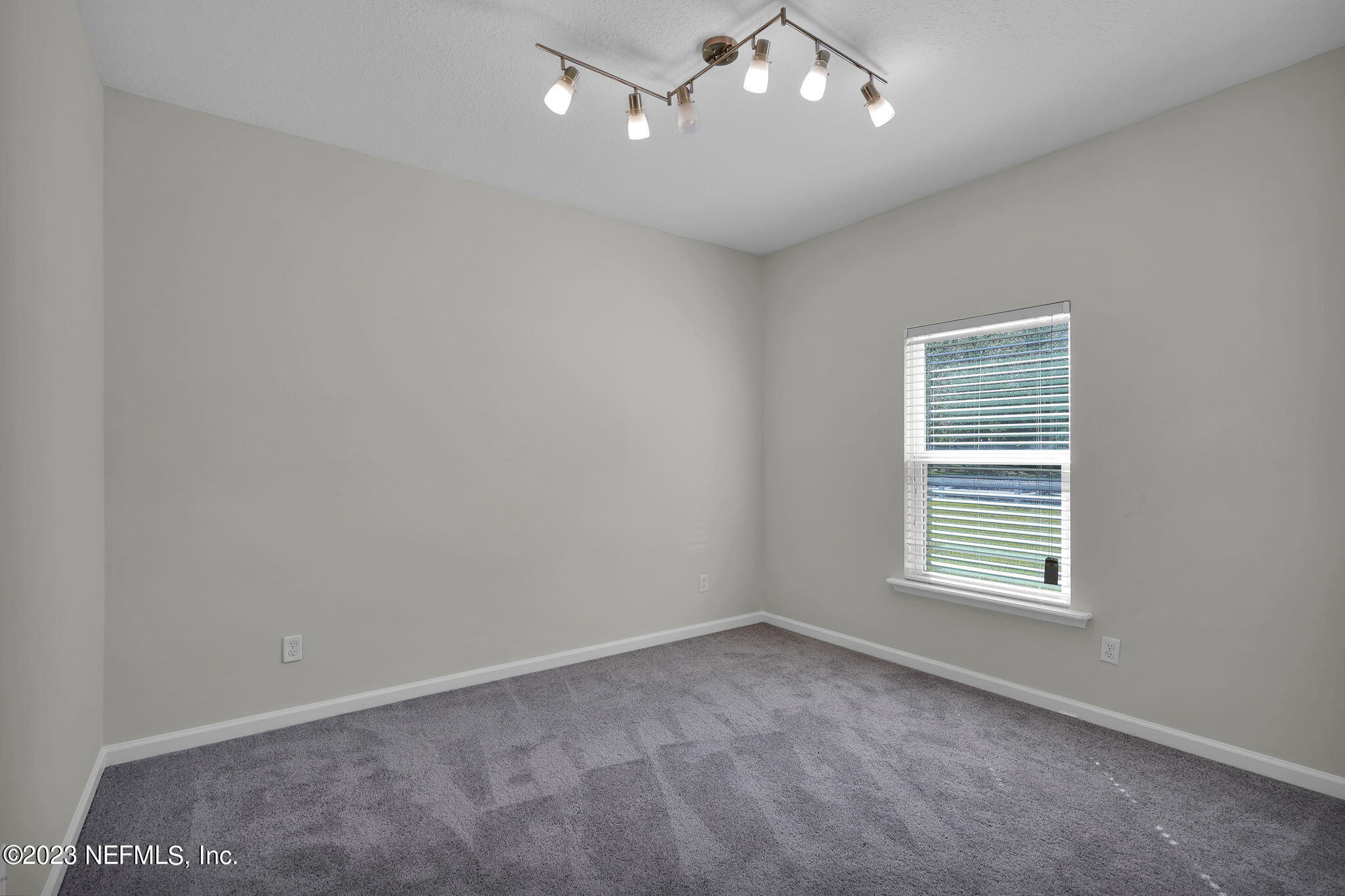 3513 Butternut Way Orange Park, FL 32065 - Photo 23 of 38 an empty room with a window and ceiling fan