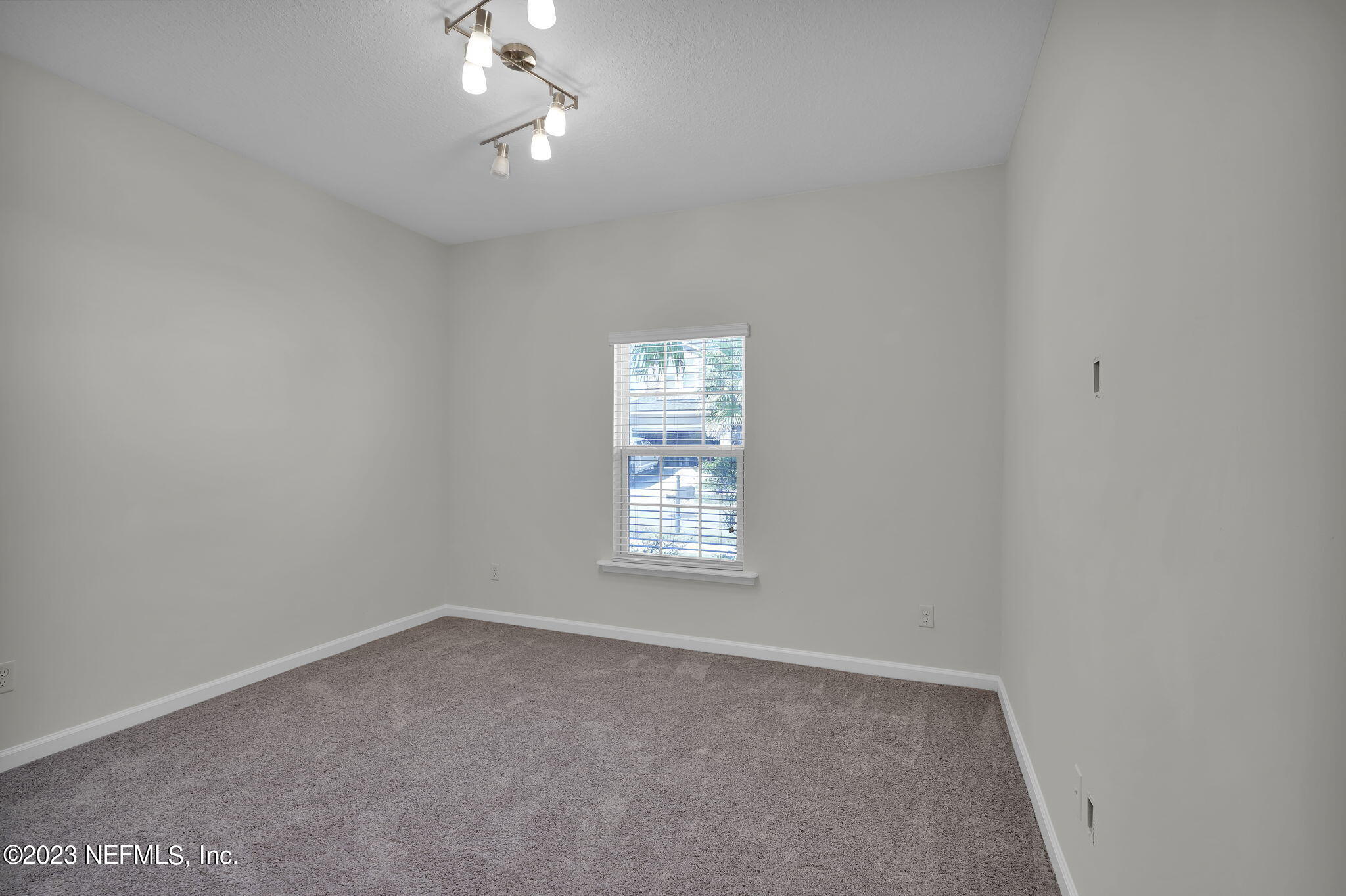 3513 Butternut Way Orange Park, FL 32065 - Photo 25 of 38 an empty room with a window and a ceiling fan