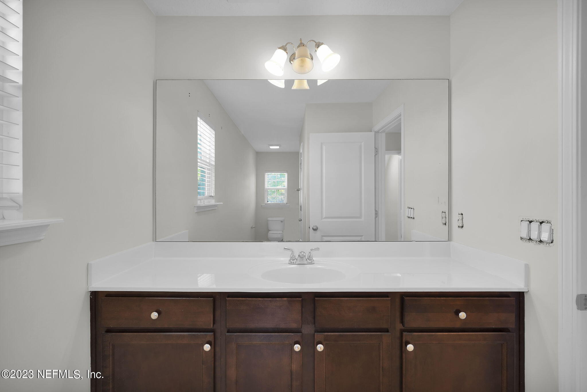 3513 Butternut Way Orange Park, FL 32065 - Photo 28 of 38 a bathroom with a sink and a mirror