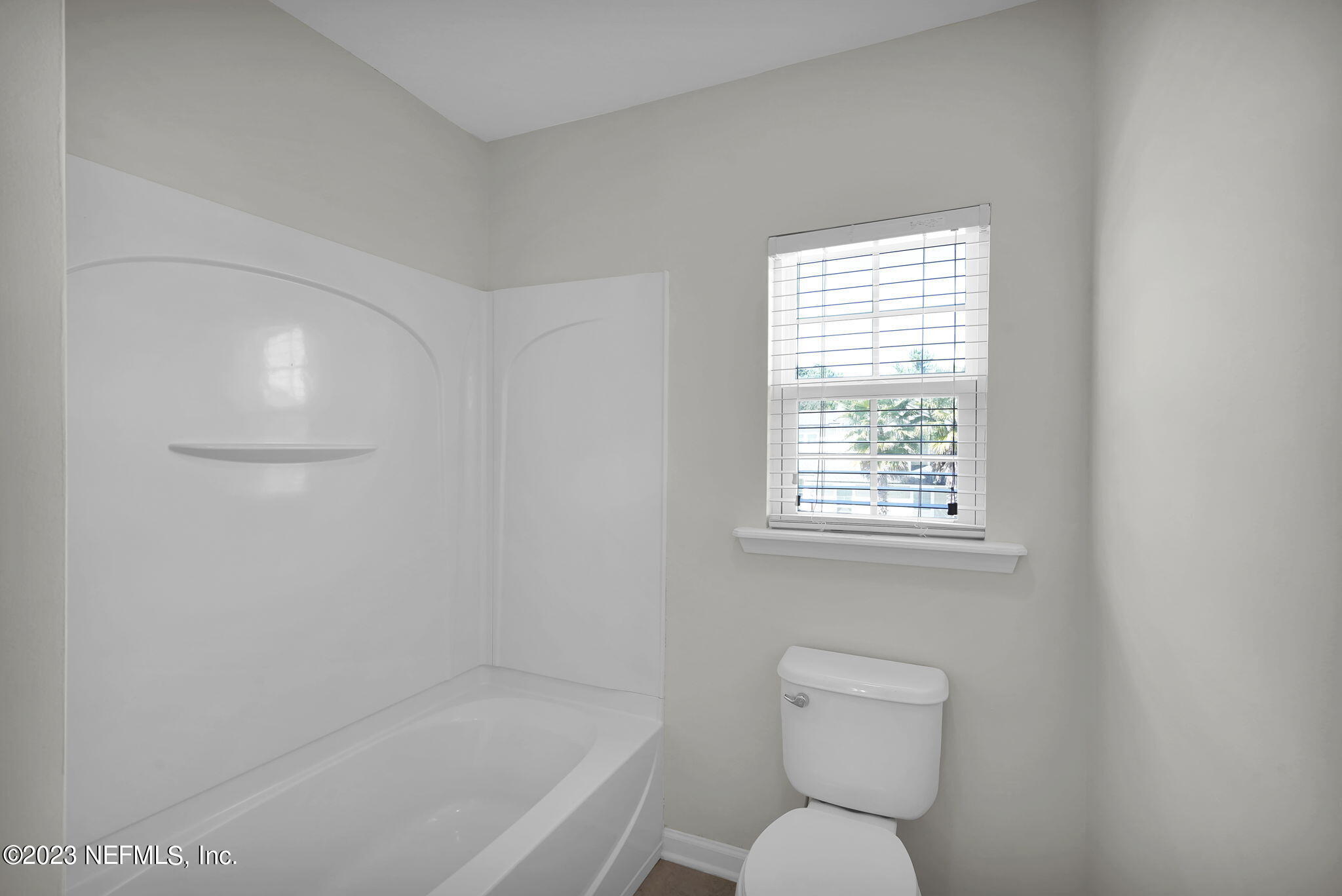 3513 Butternut Way Orange Park, FL 32065 - Photo 30 of 38 a bathroom with a toilet a sink and a window