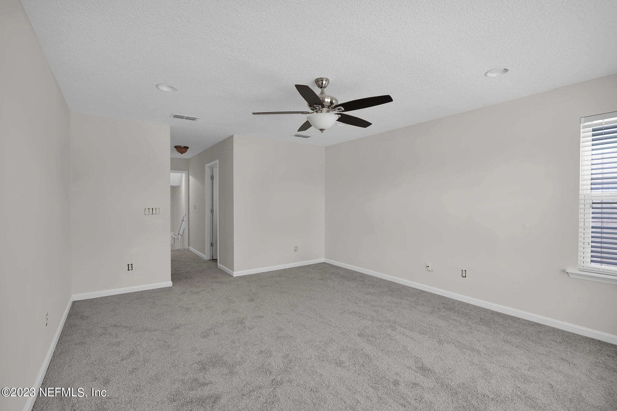 3513 Butternut Way Orange Park, FL 32065 - Photo 32 of 38 an empty room with a window and a ceiling fan