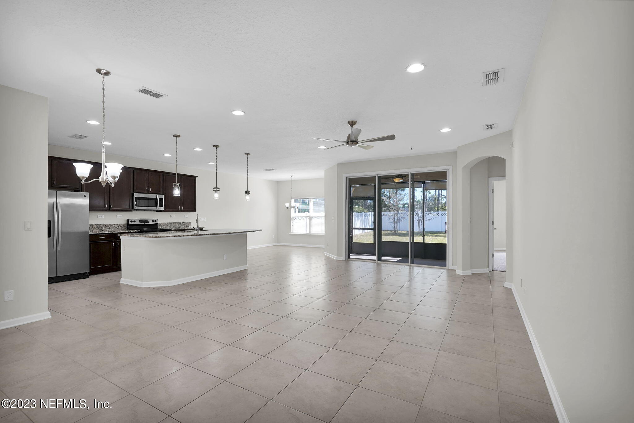 3513 Butternut Way Orange Park, FL 32065 - Photo 6 of 38 a view of an empty room with kitchen and window