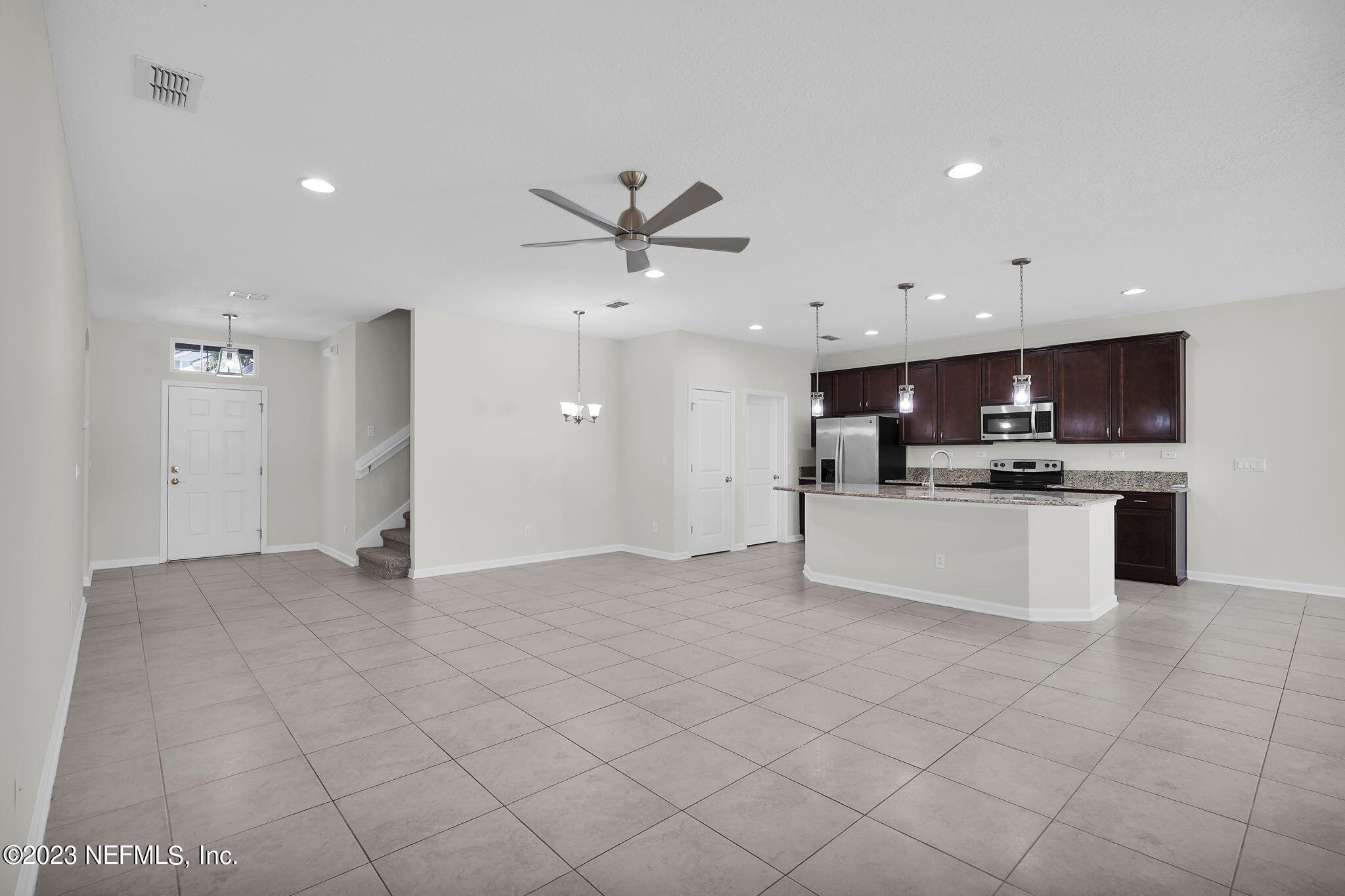 3513 Butternut Way Orange Park, FL 32065 - Photo 7 of 38 a view of kitchen with kitchen island granite countertop a sink cabinets and stainless steel appliances