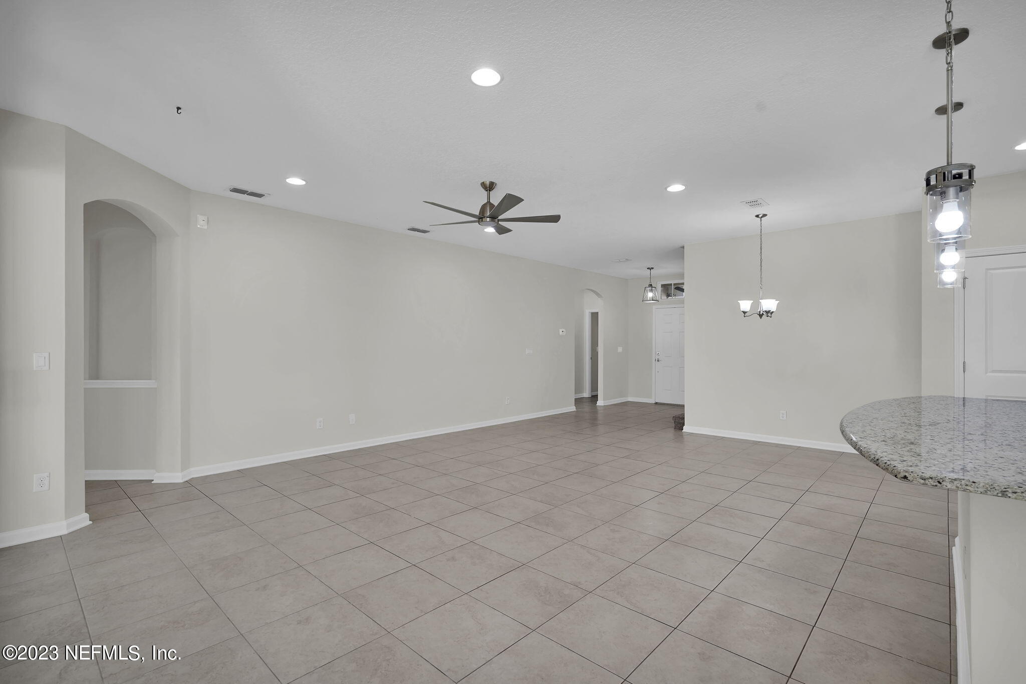 3513 Butternut Way Orange Park, FL 32065 - Photo 8 of 38 an empty room with a ceiling fan and natural light